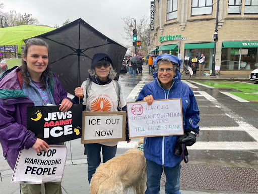 Three BWC Immigrant Justice Committee members, and a golden retriever, stand on the street corner in front of a Citizens Bank Branch. They are holding signs which read: 'Jews Against Ice,' 'Stop Warehousing People,' 'Ice Out Now', and 'Tell Citizens Bank: Stop Financing Immigrant Detention Centers.'