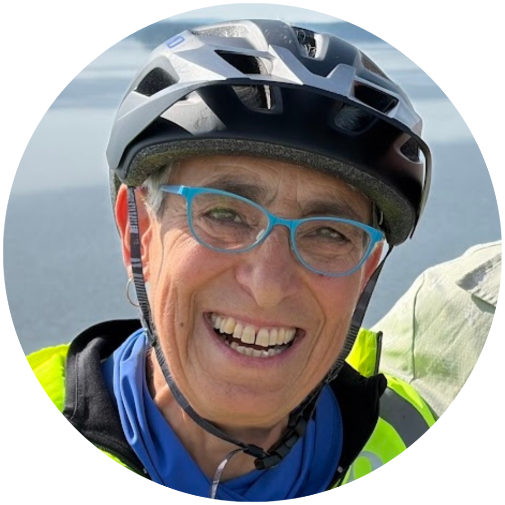headshot of Michelle Golden, a white woman wearing glasses and a biking helmet, smiling at the camera